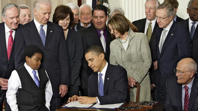 Obama signs health care bill.jpg